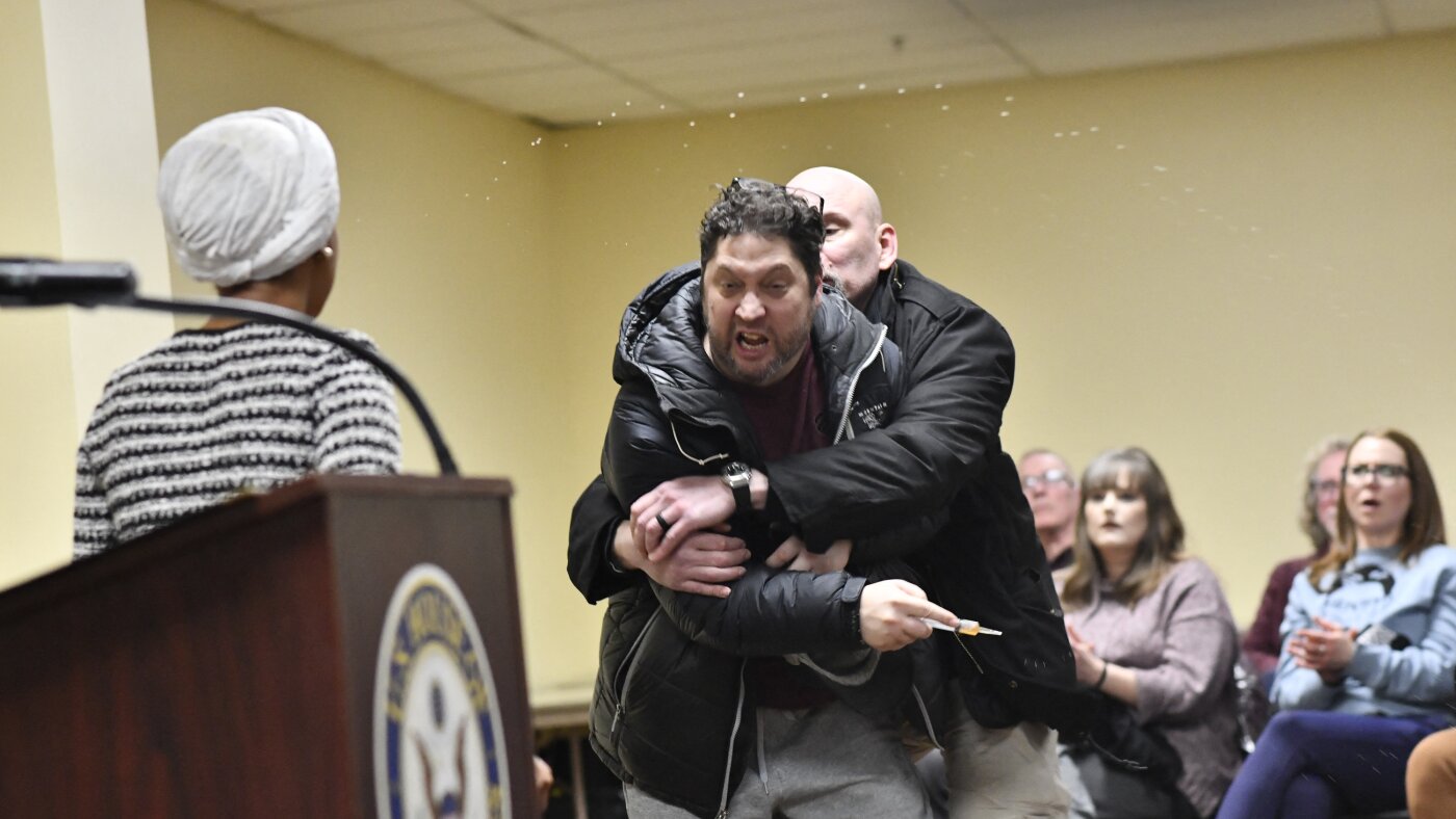 Rep. Ilhan Omar rushed on stage and sprayed with liquid at town hall event : NPR