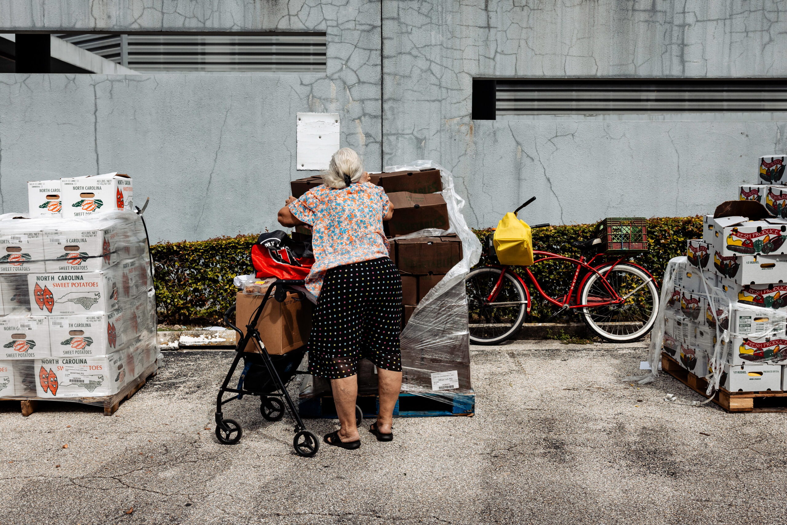 A resident receives donated food items at Curley